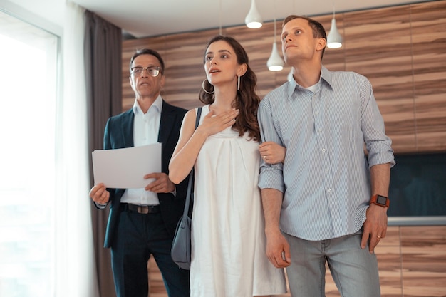 couple standing room thinking about buying house 317809 12383